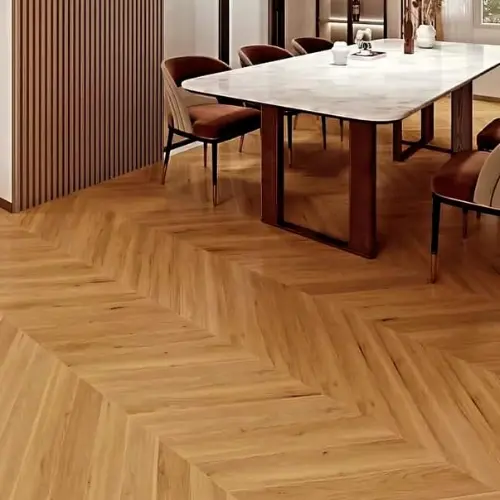 Chevron wood-effect vinyl SPC flooring laid in a dining room with panelled walls