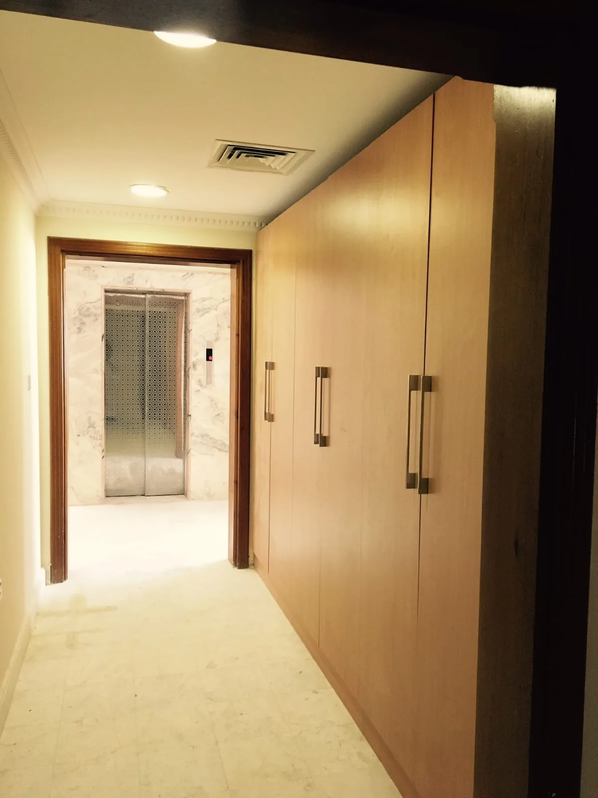Full-height wardrobe run built along a corridor wall